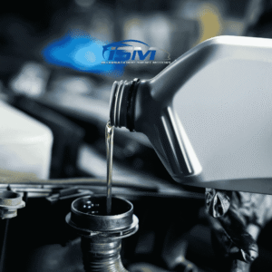 Pouring motor oil from bottle to engine close up